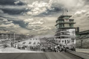 A then-and-now composite photograph by Dan Cleary showing the 1913 Indianapolis 500 starting lineup, with vintage race cars, drivers, and spectators blended into the modern Indianapolis Motor Speedway, including the pagoda, grandstands, and dramatic cloud-filled sky.