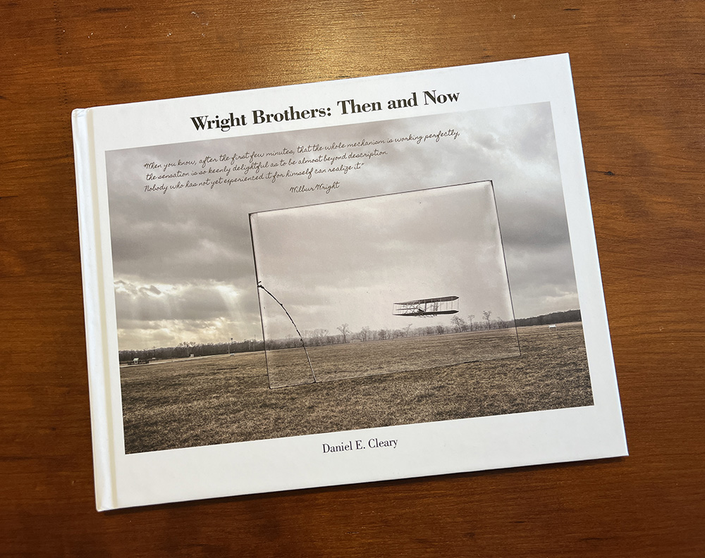 Wright Brothers- Then and Now book by Dan Cleary laying on a wooden table